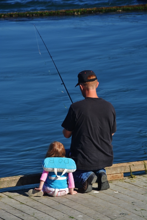 man and small daughter fishing